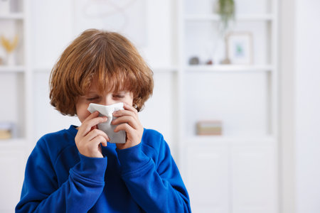 Little boy with runny nose at home, space for text. Cold symptomの写真素材