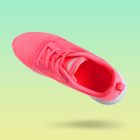 Pink sneaker in air on color gradient backgroundの写真素材