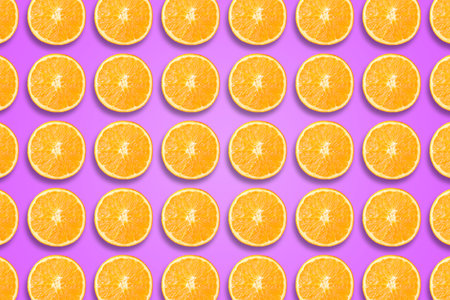 Citrus fruit pattern. Sliced oranges on violet backgroundの写真素材