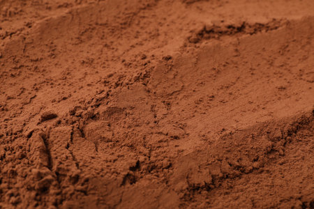 Aromatic cocoa powder as background, closeup view