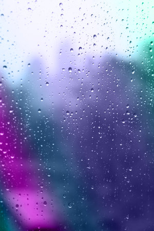 Glass window surface with water drops, closeup view
