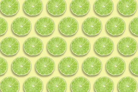 Citrus fruit pattern. Sliced limes on beige backgroundの写真素材