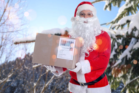 A man holding parcel in snowy forestの写真素材