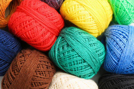 Balls of different yarns as background, closeup