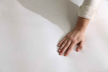 Man touching white soft mattress, top viewの写真素材