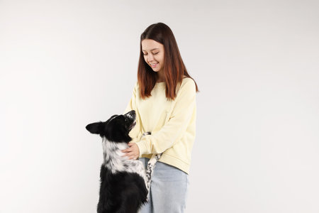 Woman with her cute Border Collie dog on white backgroundの写真素材