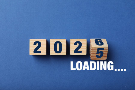 New Year loading. Wooden cubes on blue background, top view. Block with numbers 5 and 6 flippingの写真素材