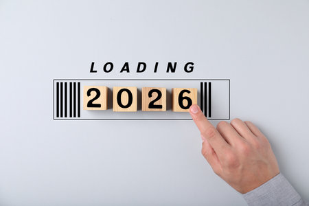 Man touching wooden cubes with numbers on light gray background, top view