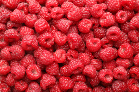 Fresh ripe raspberries as background, top view