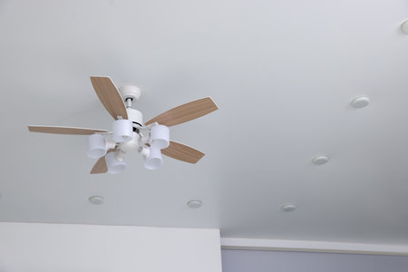 Fan lamp and spot lighting on ceiling indoors, closeupの写真素材