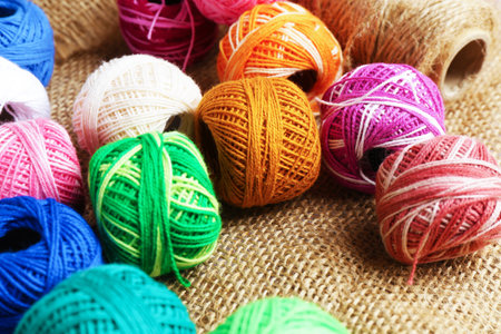 Balls of yarns on burlap fabric, closeupの写真素材