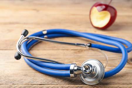Ripe apple with carved heart on wooden table, closeupの写真素材