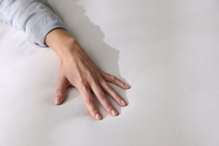 Woman touching white soft mattress, closeup viewの写真素材