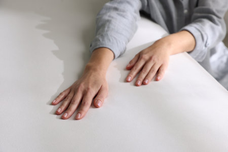 Woman touching white soft mattress, closeup viewの写真素材