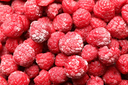 Frozen ripe raspberries as background, top viewの写真素材