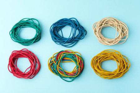 Many colorful rubber bands on light blue background, flat layの写真素材
