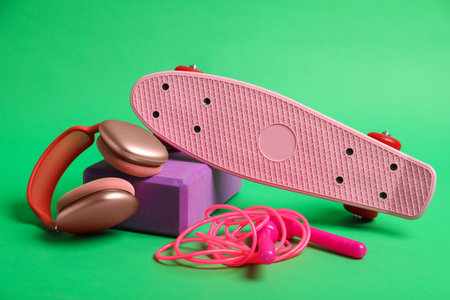 Headphones and sports equipment on green background, closeupの写真素材