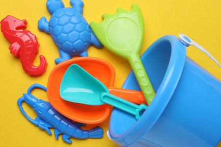 Children's beach toys on yellow background, flat layの写真素材