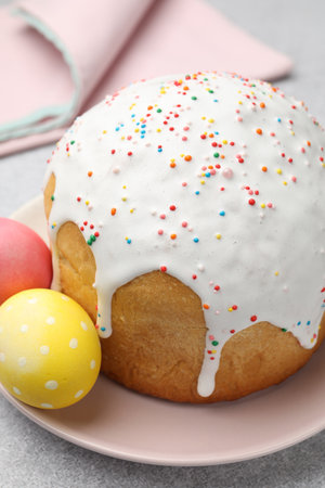 Beautiful Easter cake and eggs on light gray table, closeup