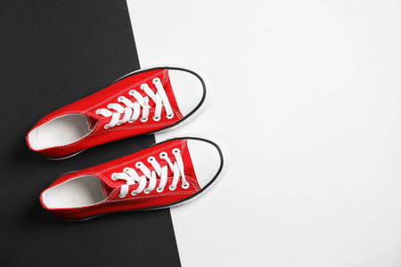 Pair of stylish sneakers on color background, top view. Space for textの写真素材