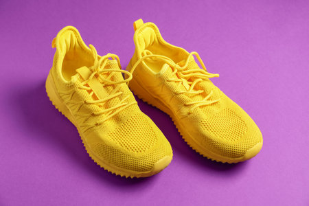 Pair of sneakers on purple background, closeupの写真素材