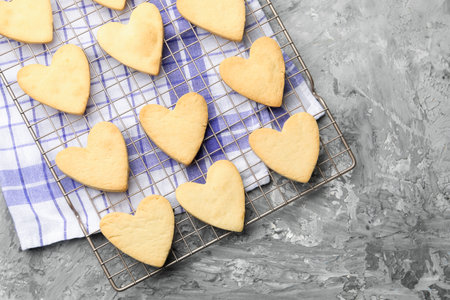 Heart shaped butter cookies on gray textured table, flat lay