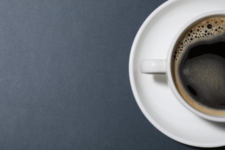 Cup of aromatic coffee on gray background, top view. Space for textの写真素材