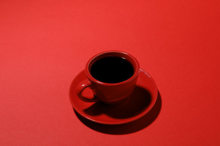 Cup of aromatic coffee on red background, closeupの写真素材