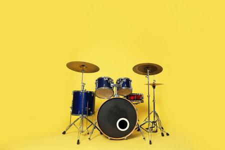 Modern drum kit on yellow background. Musical instrumentの写真素材