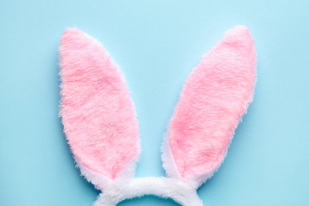 Happy Easter. Cute headband with bunny ears on light blue background, top viewの写真素材