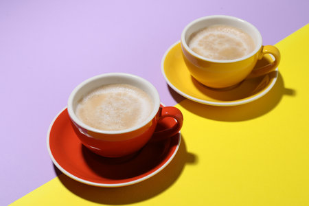 Cups of aromatic coffee on color background, closeupの写真素材