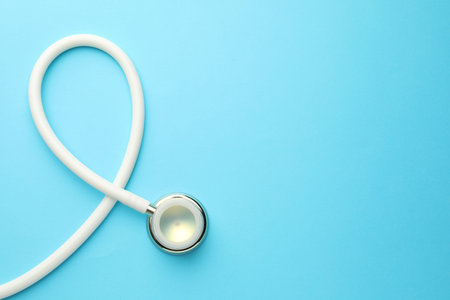 White stethoscope on light blue background, top view. Space for textの写真素材