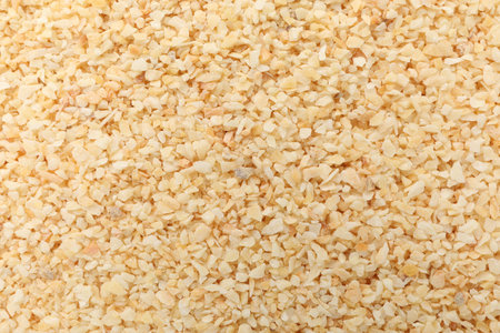 Granulated dried garlic as background, top viewの写真素材