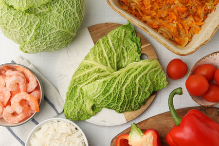 Ingredients for preparing stuffed cabbage rolls on white tiled table, flat lay