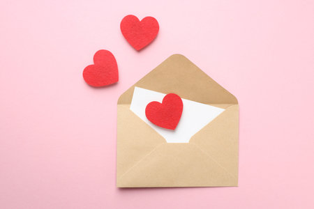 Happy Valentine's day. Envelope with greeting card and decorative hearts on pink background, flat...