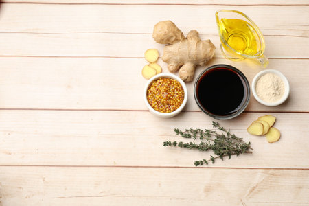 Different ingredients for marinade on wooden table, flat lay. Space for text