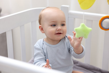 Cute little baby in crib at homeの写真素材