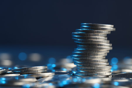Many stacked coins on table against blurred background, closeup. Space for textの写真素材