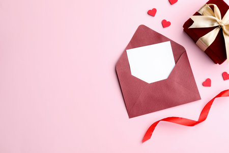 Saint Valentine's day. Beautiful gift, envelope with greeting card, decorative hearts and ribbon on...