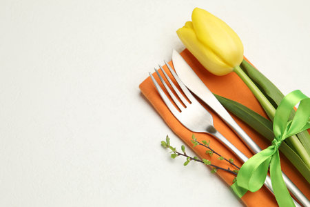 Easter celebration. Festive table setting with floral decor isolated on white, top view