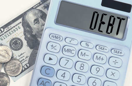 Calculator with word Debt and money on table, top viewの写真素材