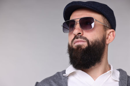 Man with mustache and beard on light gray background. Space for text