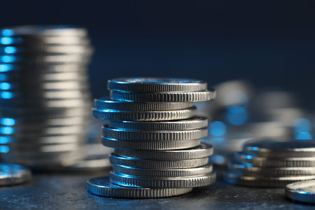 Many stacked coins on table against blurred background, closeupの写真素材
