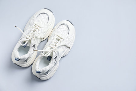 Pair of stylish sneakers on gray background, top view. Space for textの写真素材
