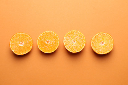 Fresh juicy tangerines on orange background, flat layの写真素材