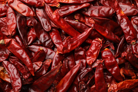 Red hot chili peppers as background, top view