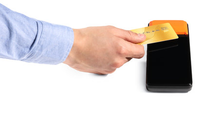Man with credit card using payment terminal on white background, closeup