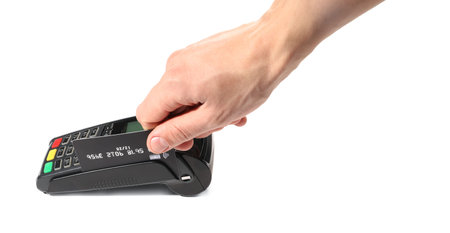 Man with credit card using payment terminal on white background, closeup