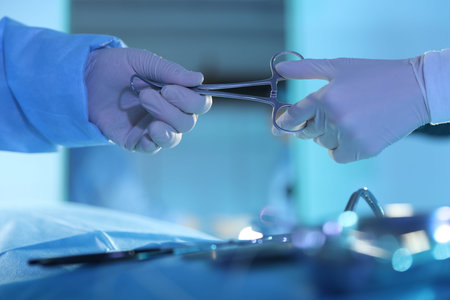 Professional surgeons with medical tools performing operation in surgery room, closeupの写真素材