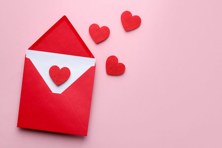 Happy Valentine's day. Envelope with greeting card and decorative hearts on pink background, flat...